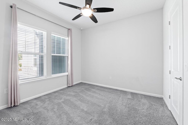 carpeted spare room with ceiling fan