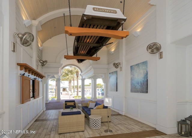 interior space featuring ornate columns, brick ceiling, and high vaulted ceiling