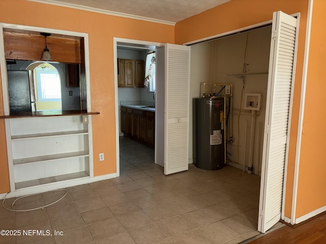 hallway featuring light tile patterned flooring and electric water heater