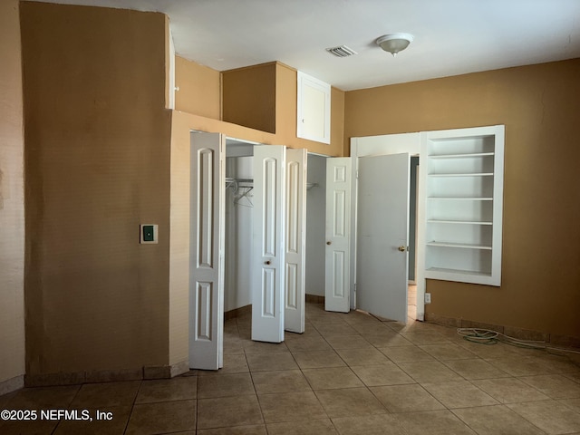 unfurnished bedroom with light tile patterned floors