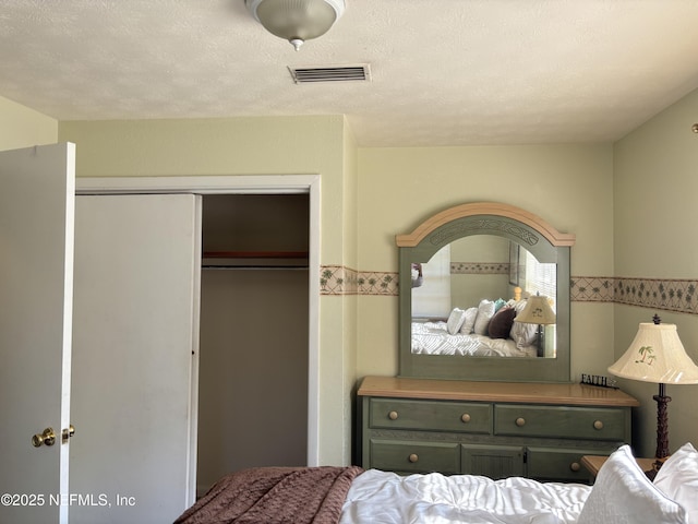 bedroom featuring a closet and a textured ceiling