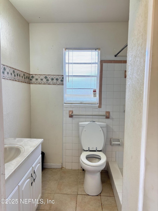 bathroom with vanity, walk in shower, tile patterned floors, and toilet