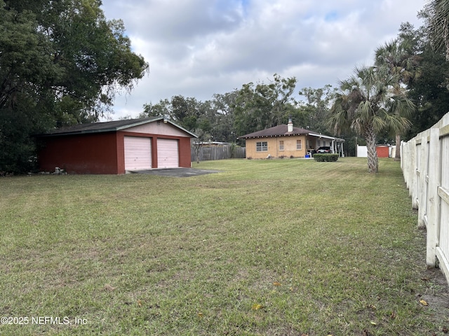 view of yard with an outbuilding and a garage