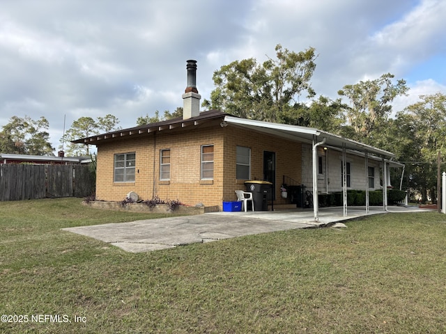 back of house with a yard and a carport