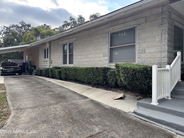 view of side of home with a carport