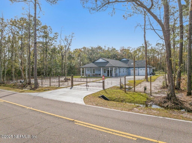 view of front of house with a fenced front yard and driveway