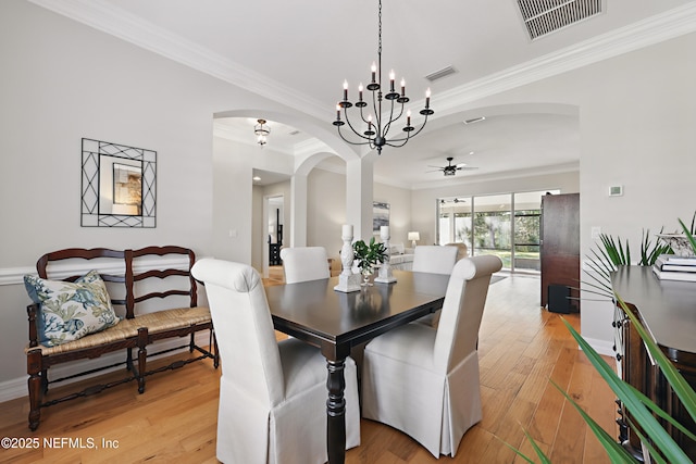 dining space featuring ceiling fan with notable chandelier, ornamental molding, and light hardwood / wood-style floors