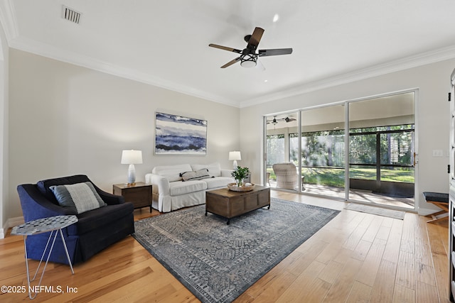 living room with crown molding, hardwood / wood-style floors, and ceiling fan