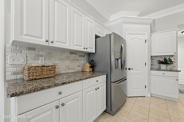 kitchen featuring white cabinetry, crown molding, and dark stone countertops