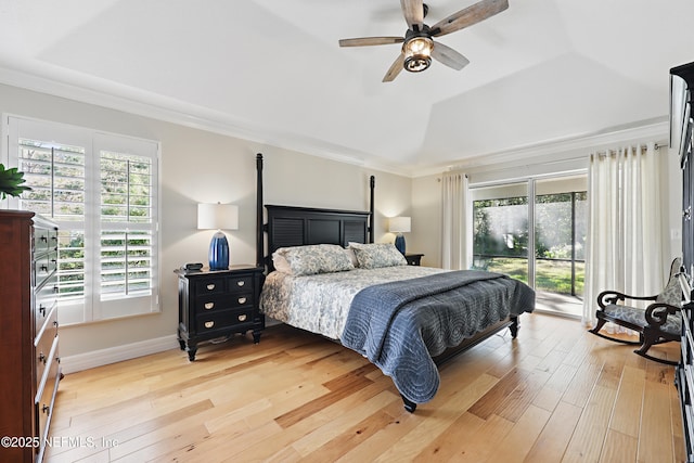 bedroom featuring hardwood / wood-style flooring, vaulted ceiling, and multiple windows