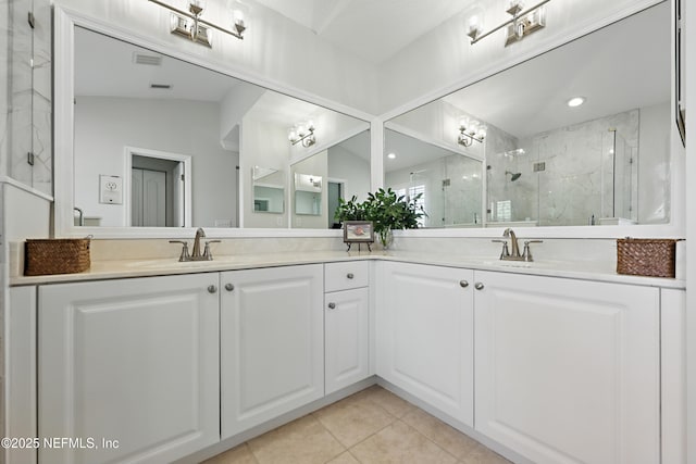 bathroom featuring vanity, tile patterned floors, and a shower with door