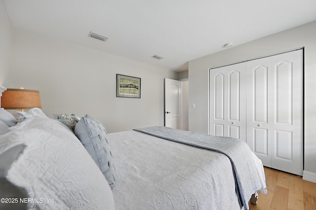 bedroom with a closet and light hardwood / wood-style flooring