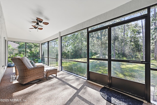 unfurnished sunroom featuring ceiling fan and lofted ceiling