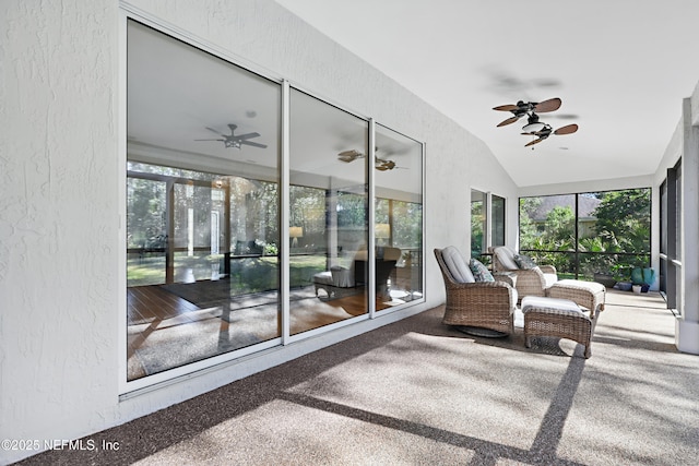 sunroom with ceiling fan and vaulted ceiling