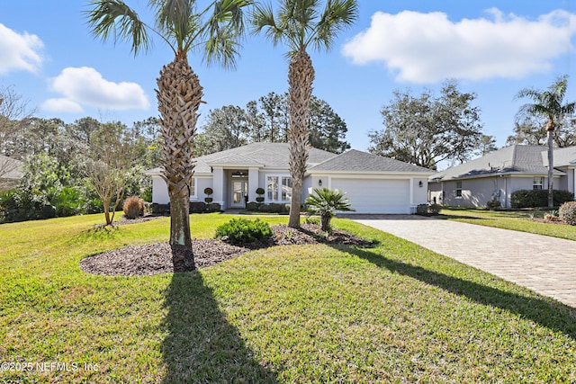 single story home with a garage and a front lawn