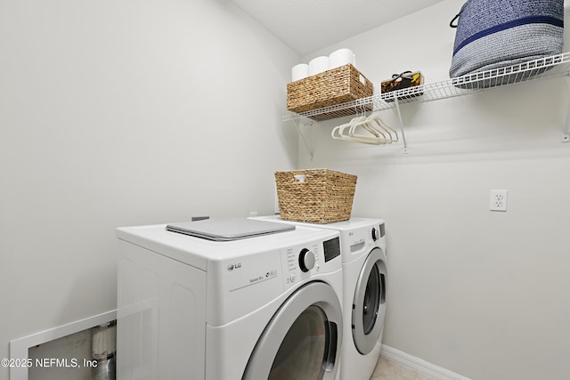 clothes washing area featuring washing machine and dryer