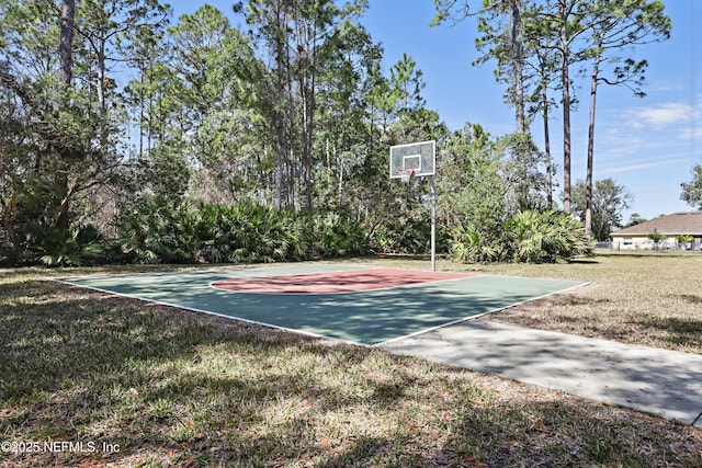 view of basketball court featuring a yard