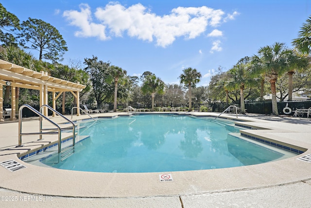 view of swimming pool with a patio and a pergola