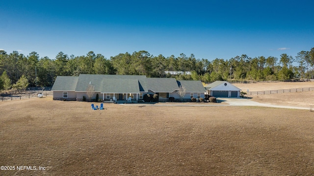 ranch-style house featuring a rural view and a front yard