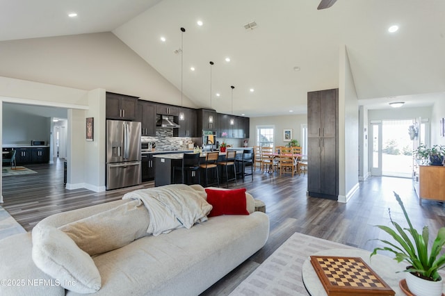 living room featuring dark hardwood / wood-style floors and high vaulted ceiling