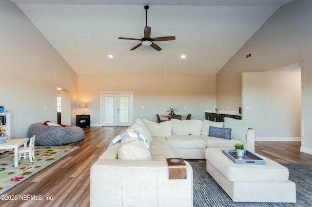 living room featuring french doors, ceiling fan, wood-type flooring, and high vaulted ceiling