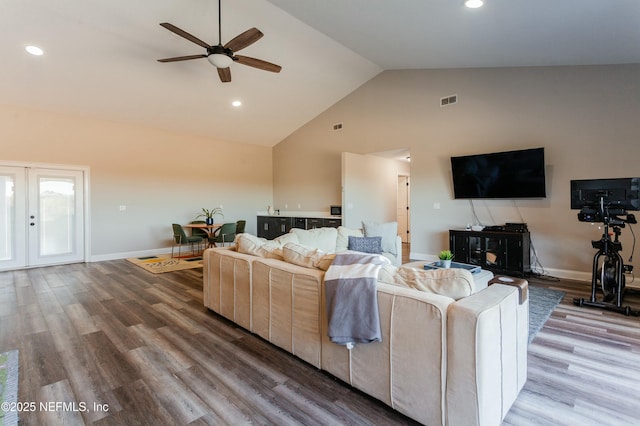 living room featuring vaulted ceiling, ceiling fan, and hardwood / wood-style floors