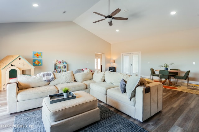 living room with ceiling fan, dark hardwood / wood-style floors, high vaulted ceiling, and french doors