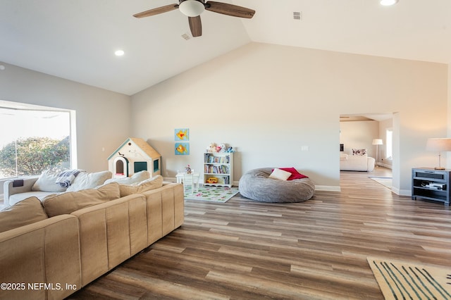 living room with hardwood / wood-style flooring, vaulted ceiling, and ceiling fan