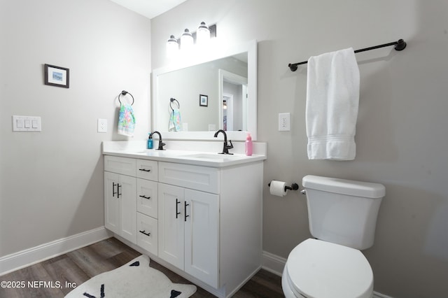 bathroom with vanity, hardwood / wood-style flooring, and toilet