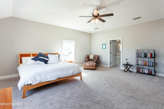 bedroom with lofted ceiling, carpet floors, ceiling fan, and ensuite bath