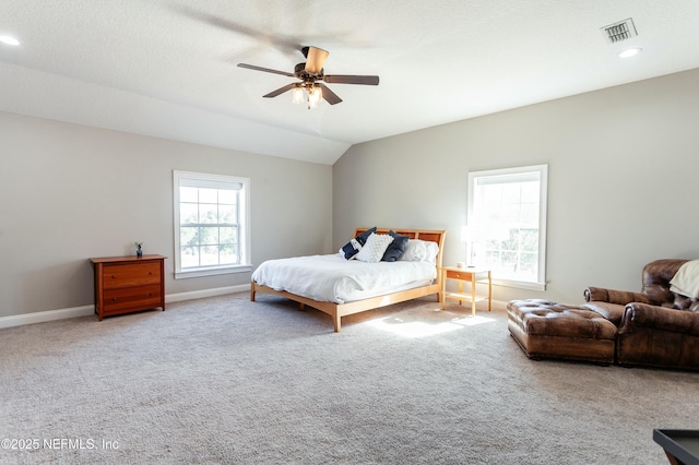 carpeted bedroom with vaulted ceiling and ceiling fan