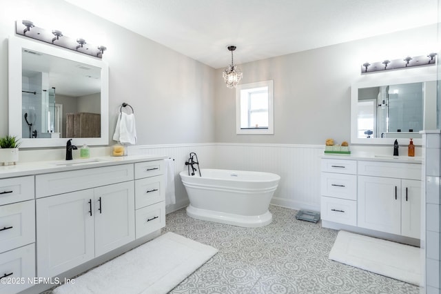 bathroom featuring vanity, plus walk in shower, a chandelier, and tile patterned flooring