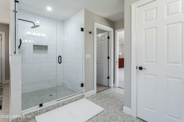 bathroom with tile patterned floors and a shower with shower door