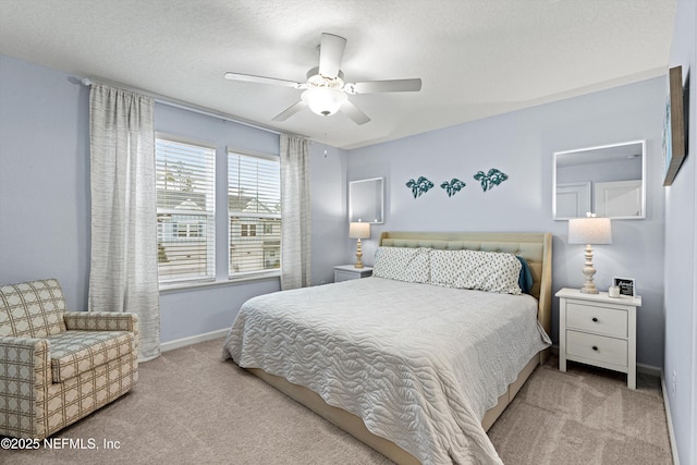 bedroom with light colored carpet, a textured ceiling, and ceiling fan