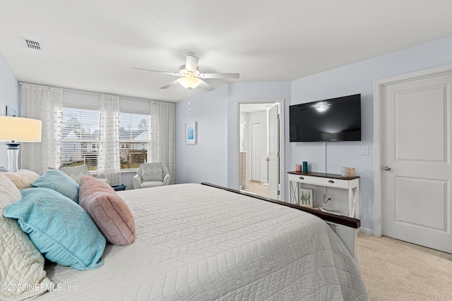 bedroom with light carpet, a textured ceiling, and ceiling fan