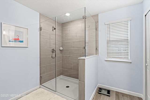 bathroom featuring an enclosed shower and a textured ceiling