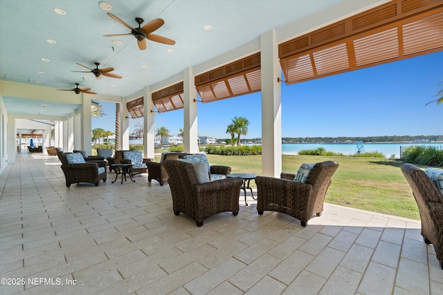 view of patio with a water view and an outdoor hangout area