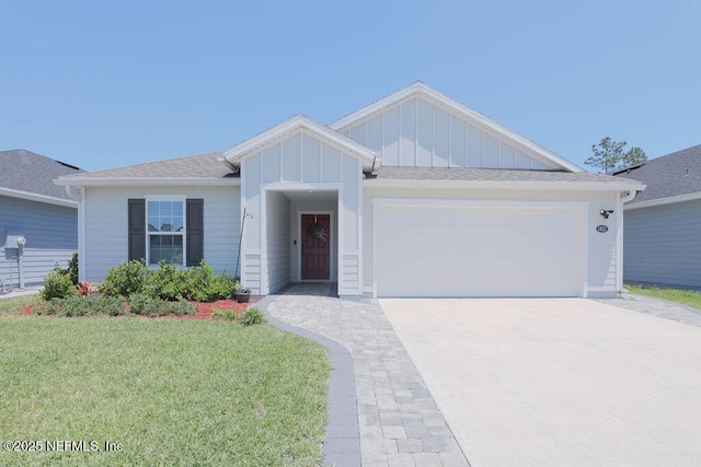 ranch-style house featuring a garage and a front lawn