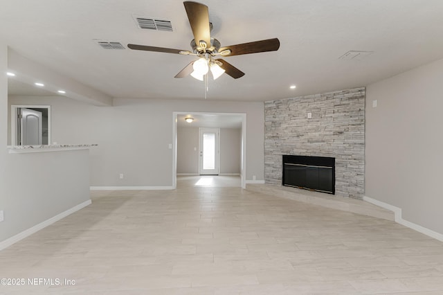 unfurnished living room featuring ceiling fan and a fireplace