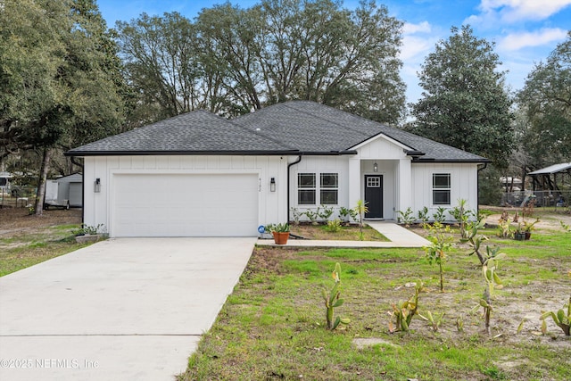 view of front facade featuring a garage, concrete driveway, a shingled roof, and board and batten siding