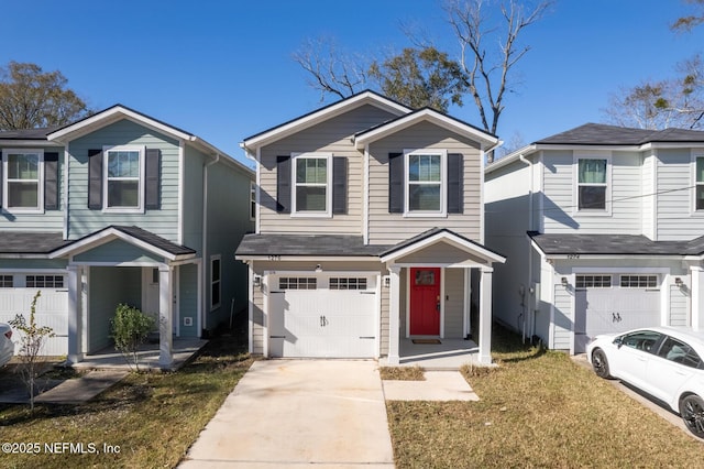 view of property featuring a garage and a front lawn