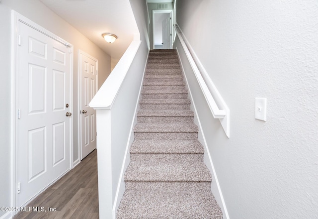 staircase featuring wood-type flooring