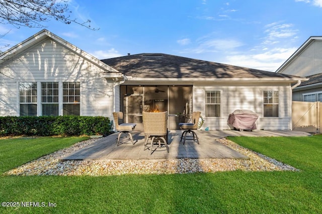 rear view of house with a patio area and a lawn