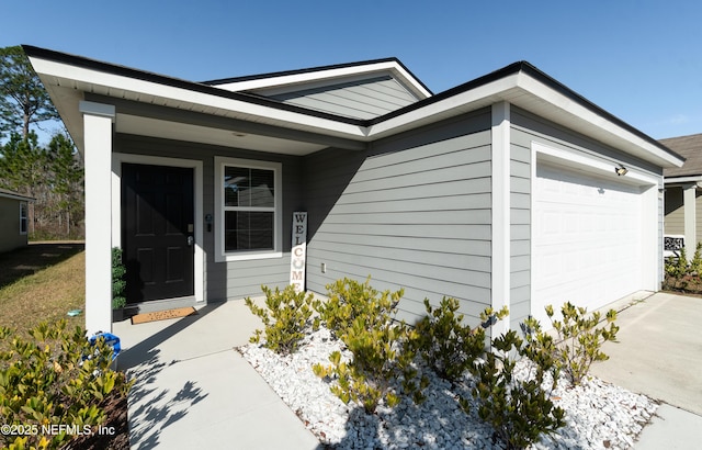 view of exterior entry featuring a garage