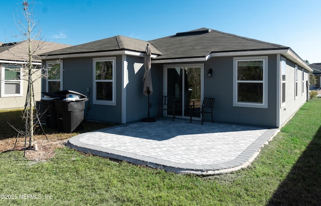 rear view of property with a patio area and a lawn