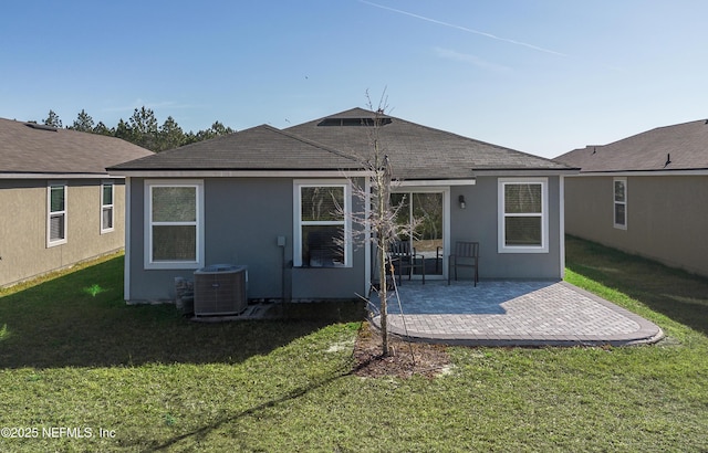 back of house with cooling unit, a patio area, and a lawn