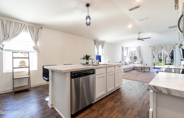 kitchen featuring white cabinets, a center island with sink, dark hardwood / wood-style flooring, decorative light fixtures, and stainless steel dishwasher