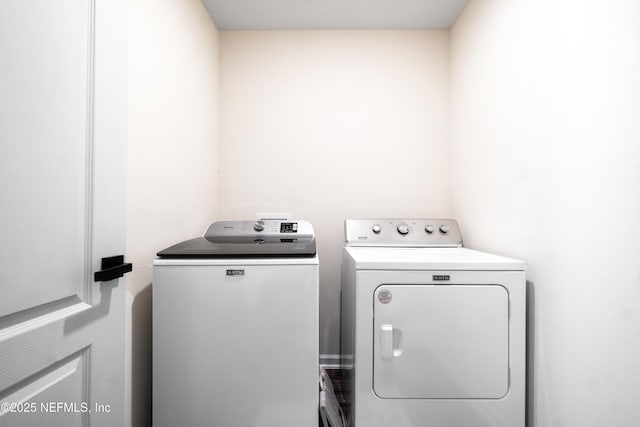 clothes washing area with washing machine and dryer