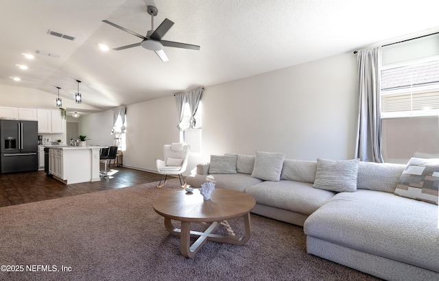 living room with lofted ceiling, dark hardwood / wood-style floors, and ceiling fan