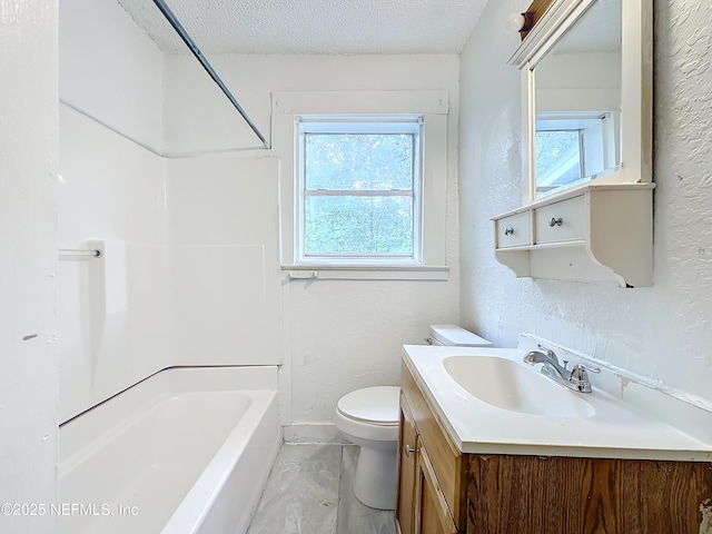 full bathroom with vanity, bathtub / shower combination, a textured ceiling, and toilet